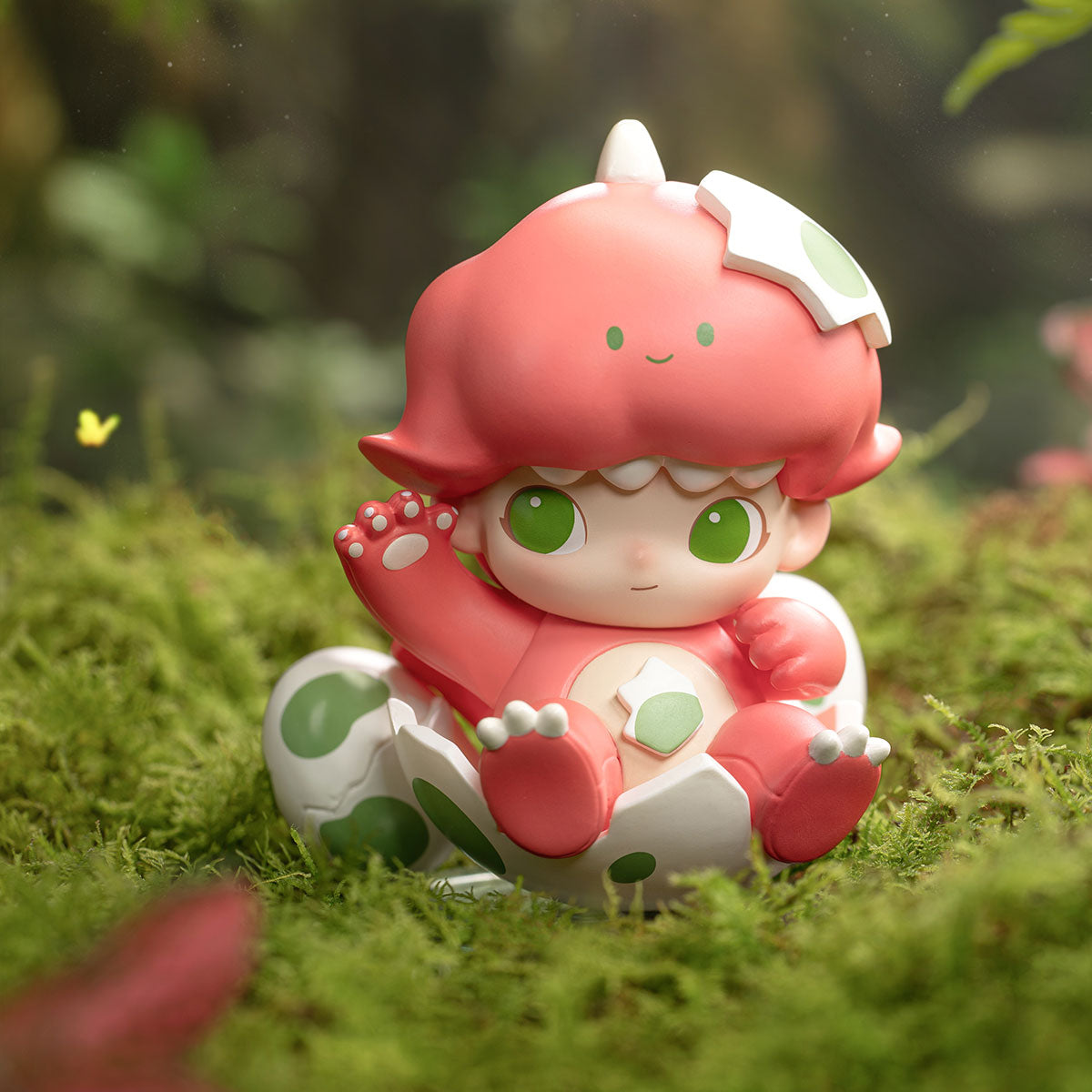 DIMOO Jurassic World Series figure in dino costume hatching from an egg, set on moss. Preorder for October 2025 release at Strangecat Toys.
