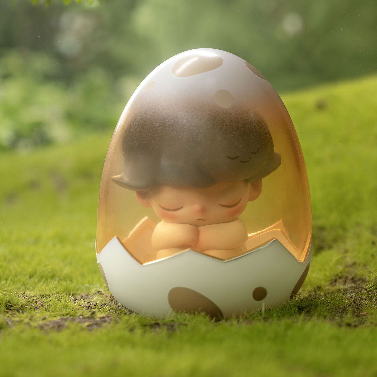 DIMOO Jurassic World Series figurine: a child sleeping inside a cracked eggshell on grass, part of a 12-design preorder collection.