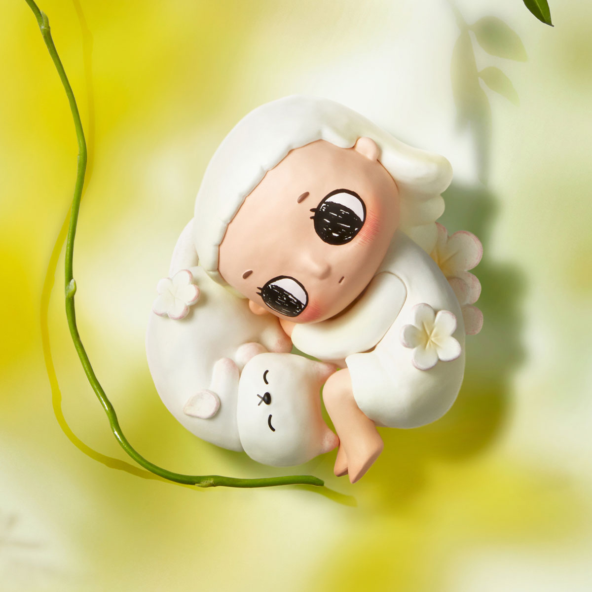 Nyota I Am the Seasons Series Figures - Preorder: A clay figurine of a girl with a sleeping creature, decorated with flowers, available for preorder.