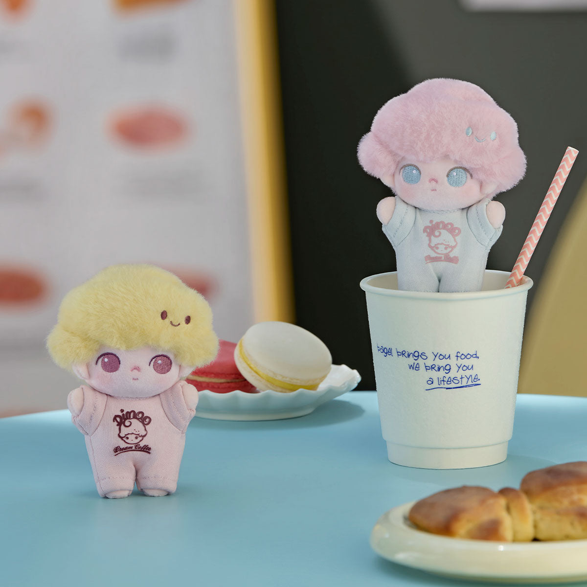 DIMOO Crush on Coffee Series plush keychains in café setting with macarons and croissant, featuring two dolls in pastel overalls, available for preorder.