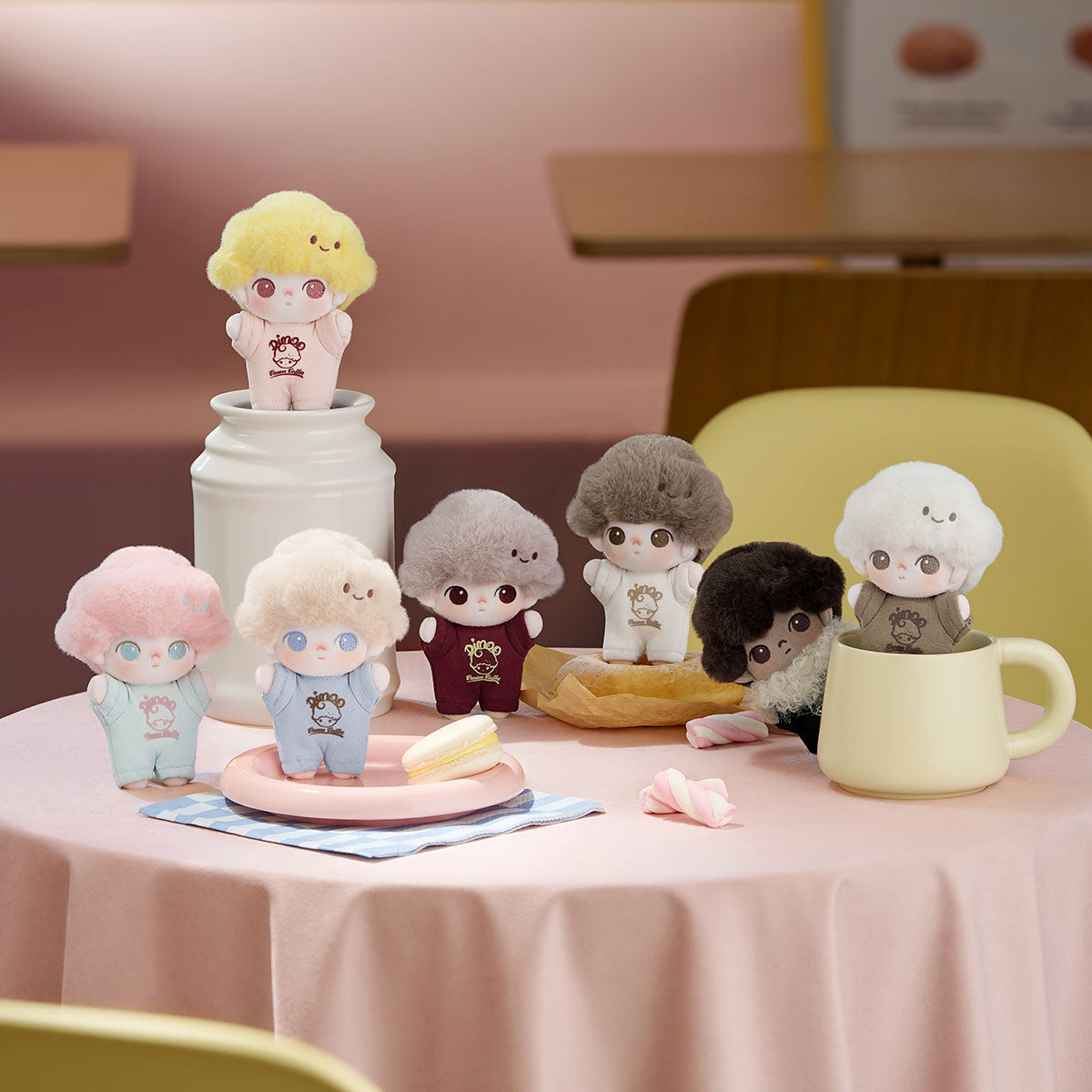 Tiny plush figures from the DIMOO Crush on Coffee Series-Soft-faced Plush Keychain Blind Box arranged around a tea party scene with treats.