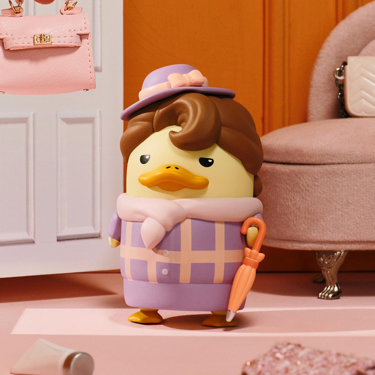 The Grand DUCKOO Hotel Series Figure, a stylized duck in pastel attire with a bowler hat and umbrella, available for preorder from Strangecat Toys.