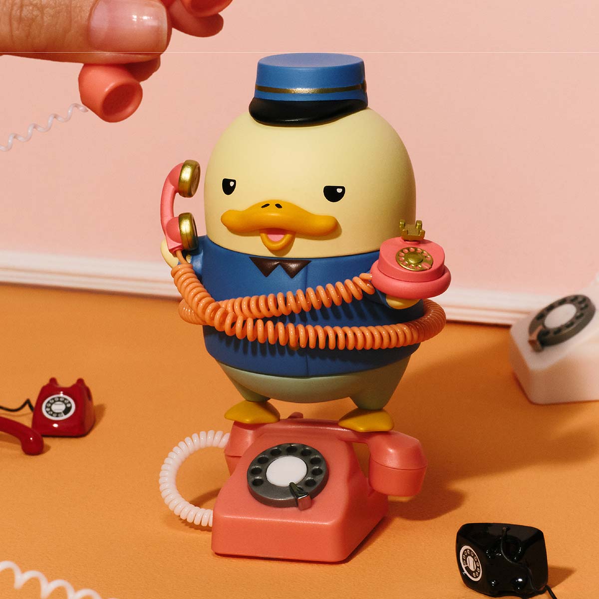The Grand DUCKOO Hotel Series figure: a duck in uniform on a vintage phone, part of Strangecat Toys' preorder collection.