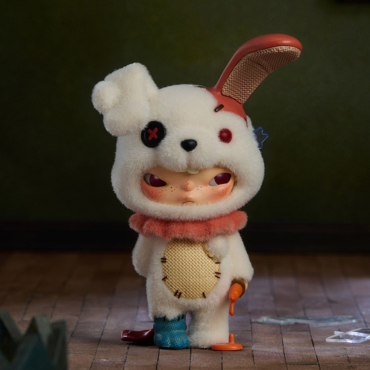 Hirono Monsters' Carnival Series Figure: A bunny-costumed character with mismatched feet, holding a dripping carrot, standing amidst glass shards. Preorder for November 2025.