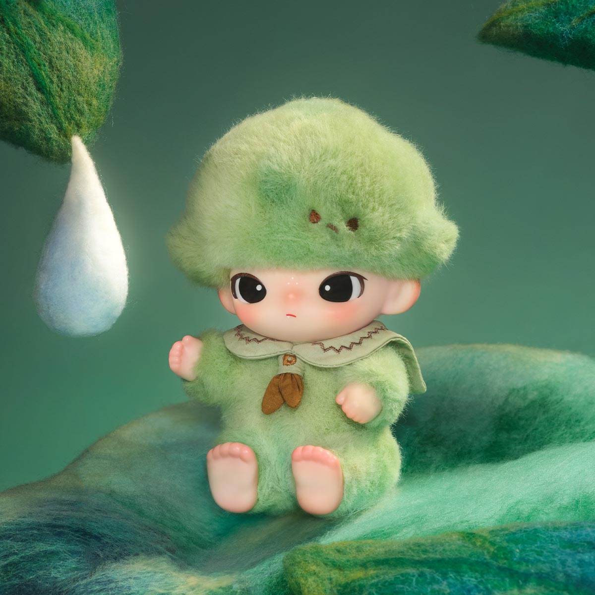 DIMOO Journal of New Life Series: A whimsical, 3D-rendered baby in a moss-green outfit, sitting on a felted surface with a woolly droplet beside it.