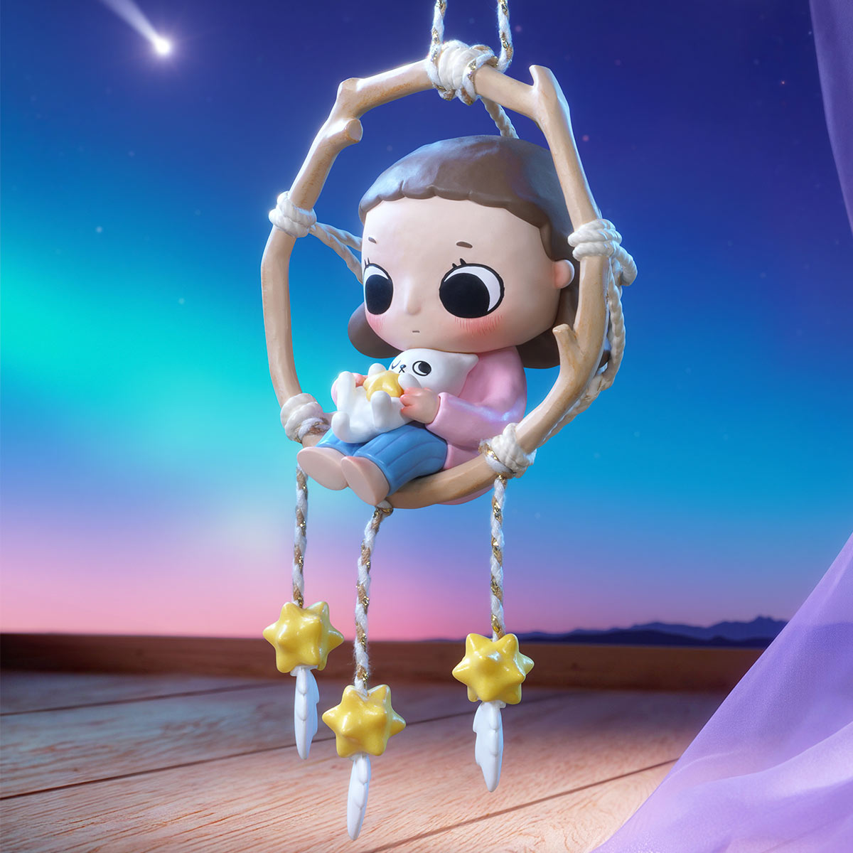 Nyota We are All Stars Series Figure: Cartoon girl in a swing cradling a cat, with stars and feathers, set against a twilight sky. Preorder available.