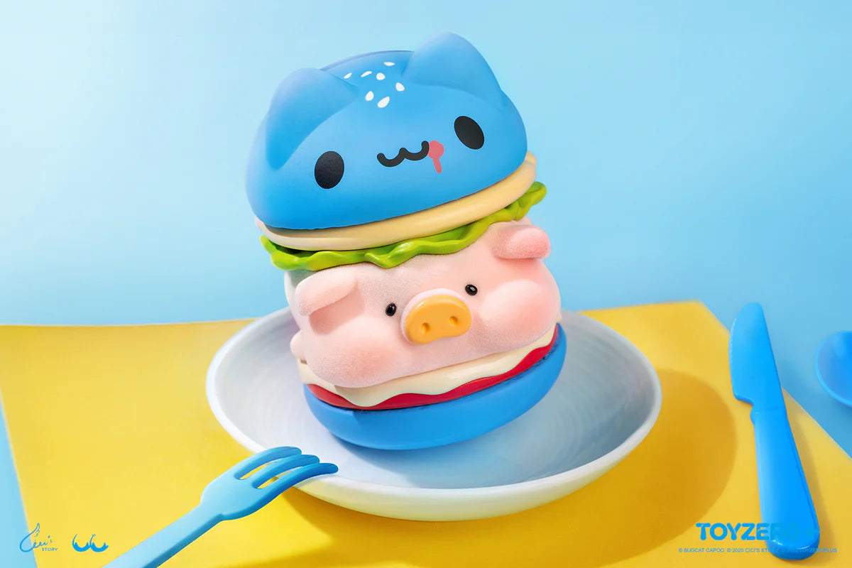 LuLu the Piggy x Capoo - LuLuBurger toy featuring a cat-bun, pig-face patty, and detachable layers, displayed on a plate with blue utensils.