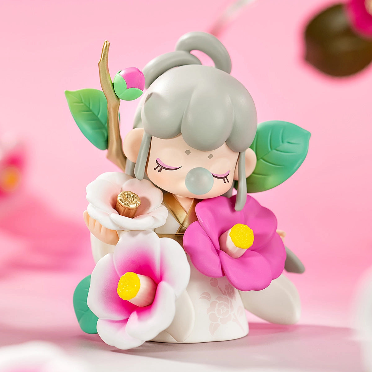 Nanci's Flower Stories Blind Box Series featuring a detailed pink flower figurine, part of a 12-design collectible toy collection with a mystery option.