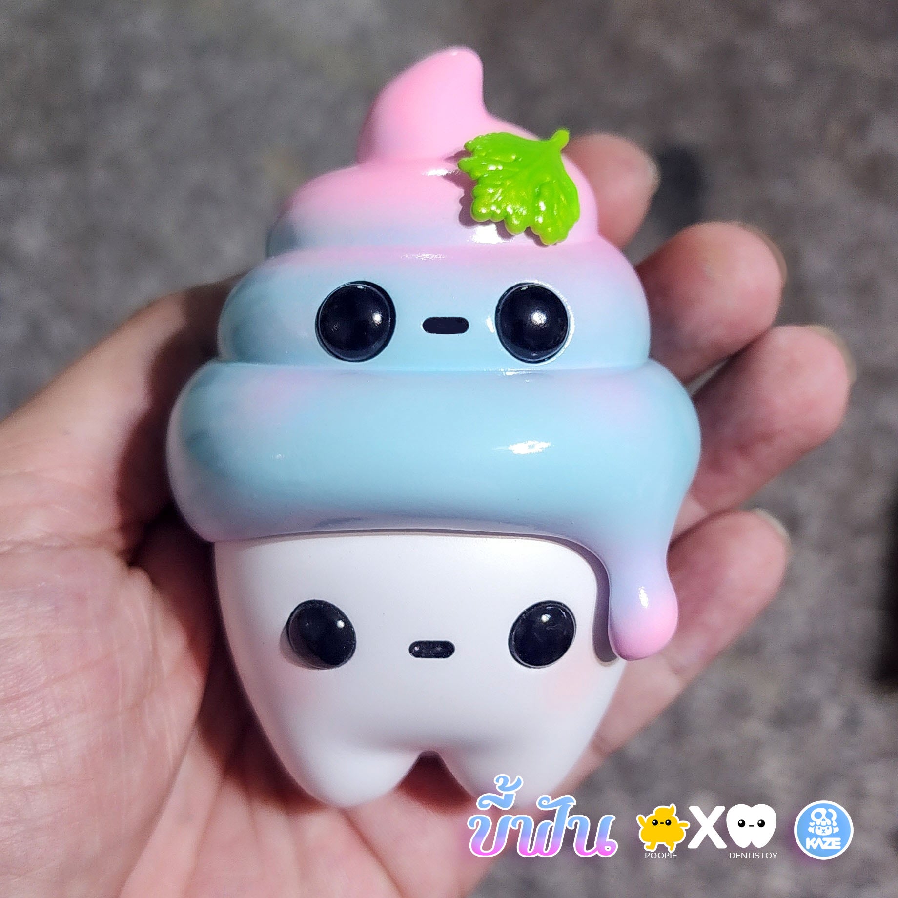 A hand holding a toy - Poopie X Dentistoy by Kaze Studio, limited edition handmade resin, 9.5 cm size.