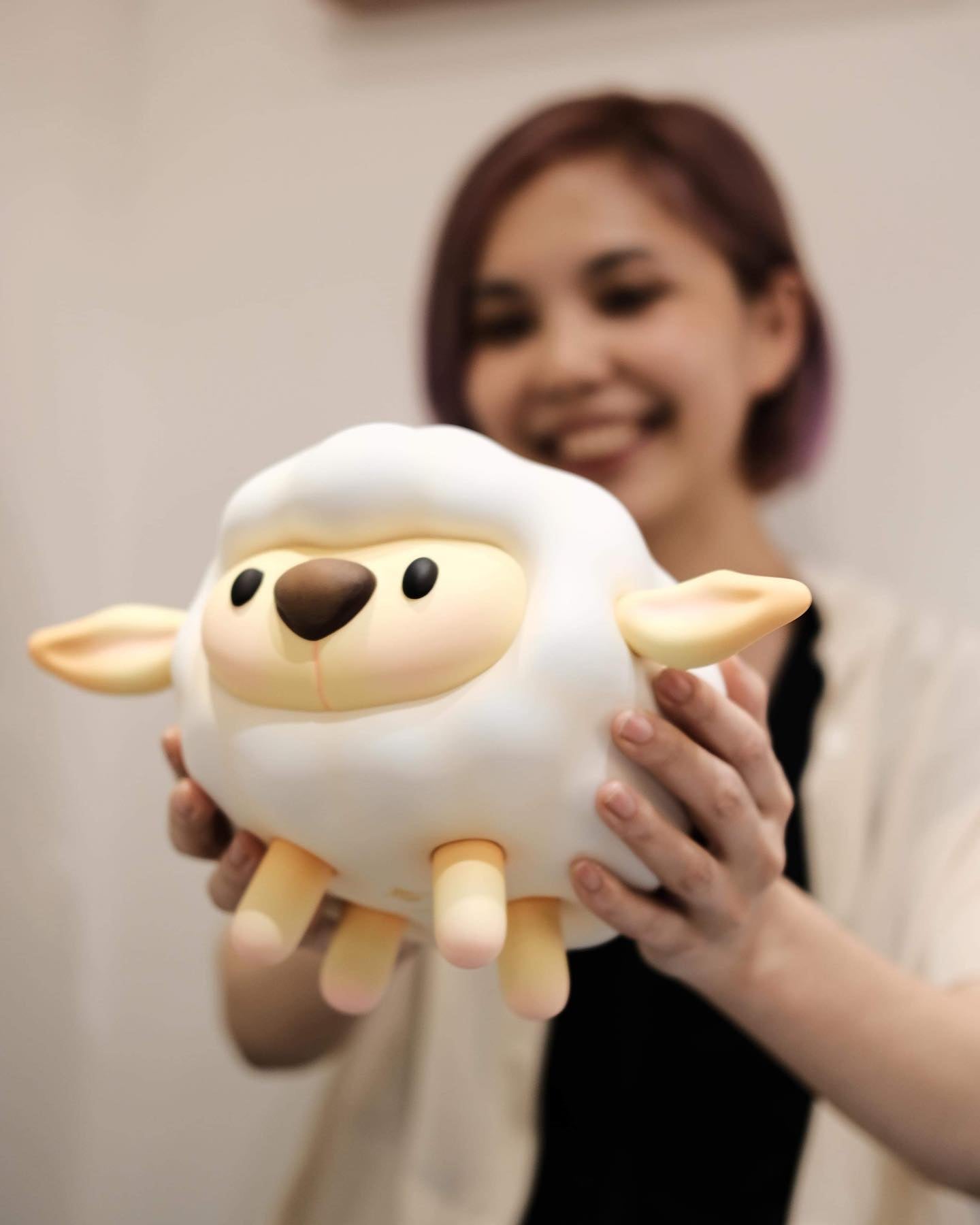 BoPeep Sheep XL by FufuFanny: Woman holding toy sheep and black oval object, vinyl+magnet, 17.3cm.