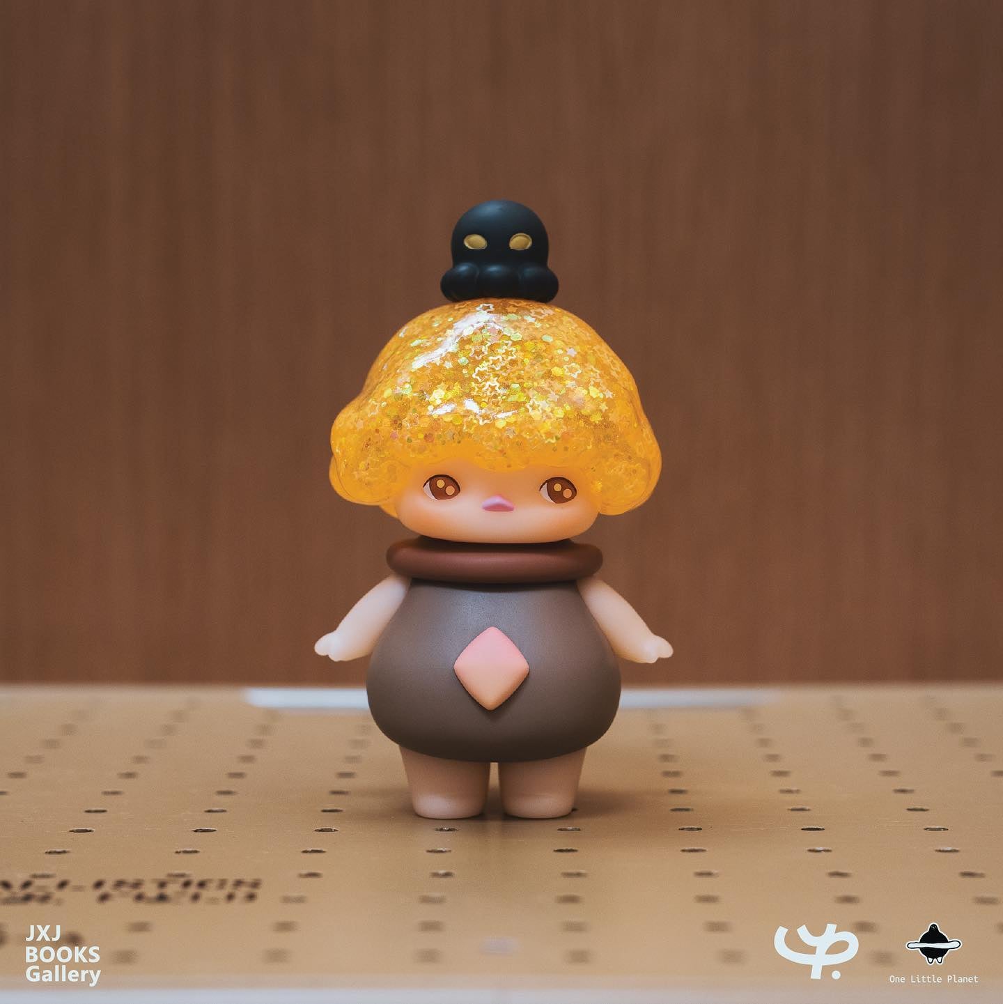 Toy figurine with black skull and yellow hair, part of Golden Sun by Pucky collection.