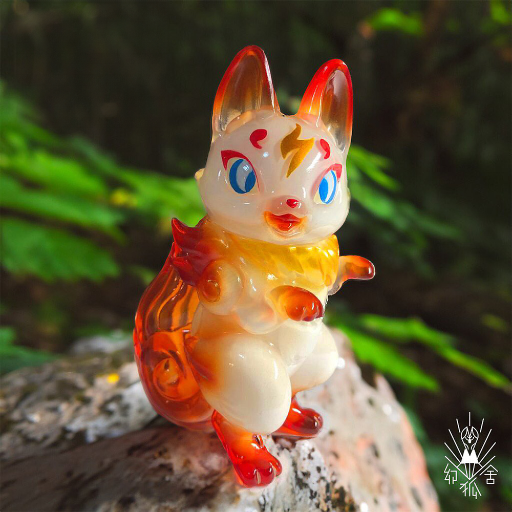 Roaring phantom fox figurine, a plastic cat animal toy on a rock.