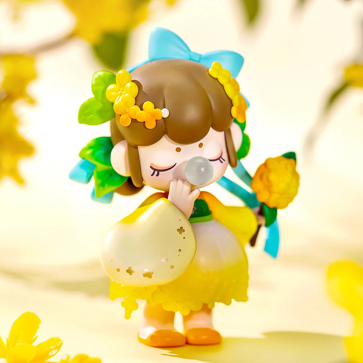 Nanci's Flower Stories Blind Box Series featuring a toy figurine of a girl blowing a bubble, part of a 12-design collectible set.