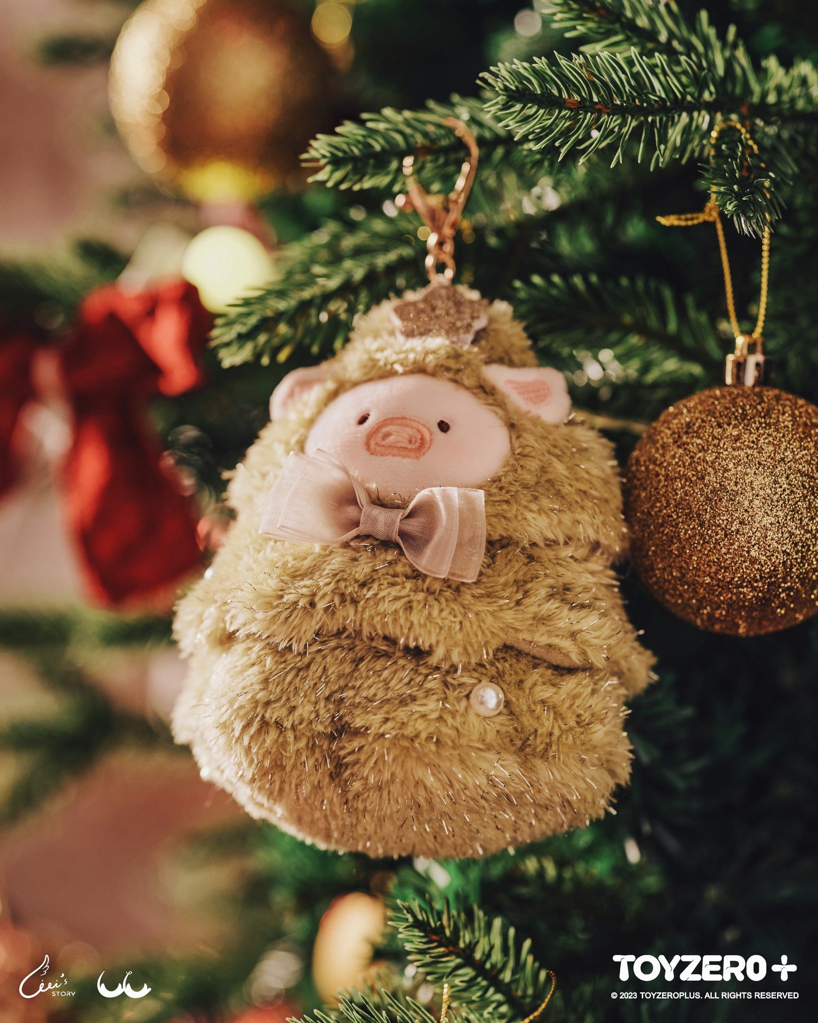 LuLu the Piggy X'Mas keychain nestled on a Christmas tree, embodying a festive elf spirit.