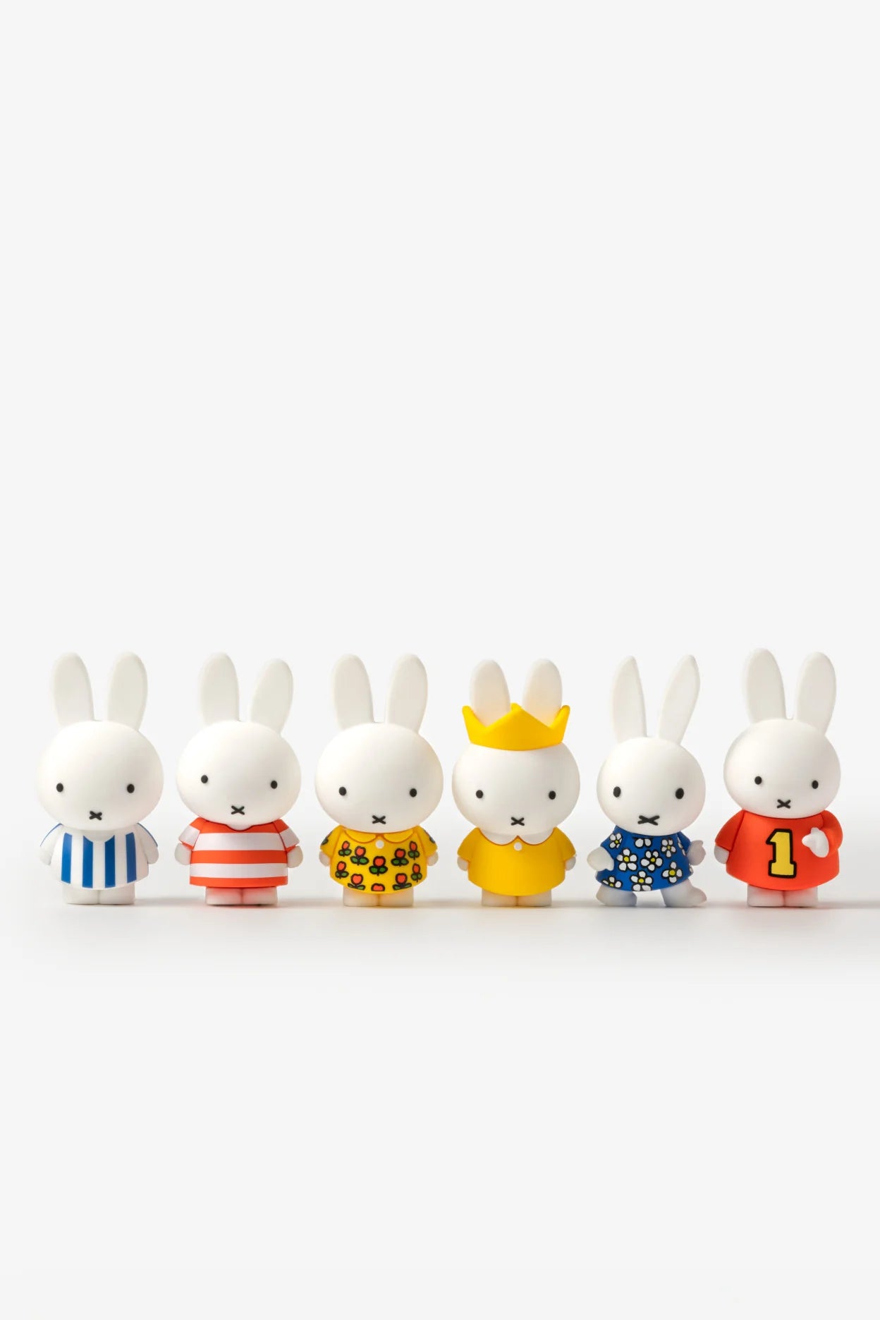 Smoko Miffy Dressing Up Blind Box Figure featuring six collectible vinyl rabbit figures in colorful outfits, including a crowned Miffy. For ages 15+, U.S. exclusive.
