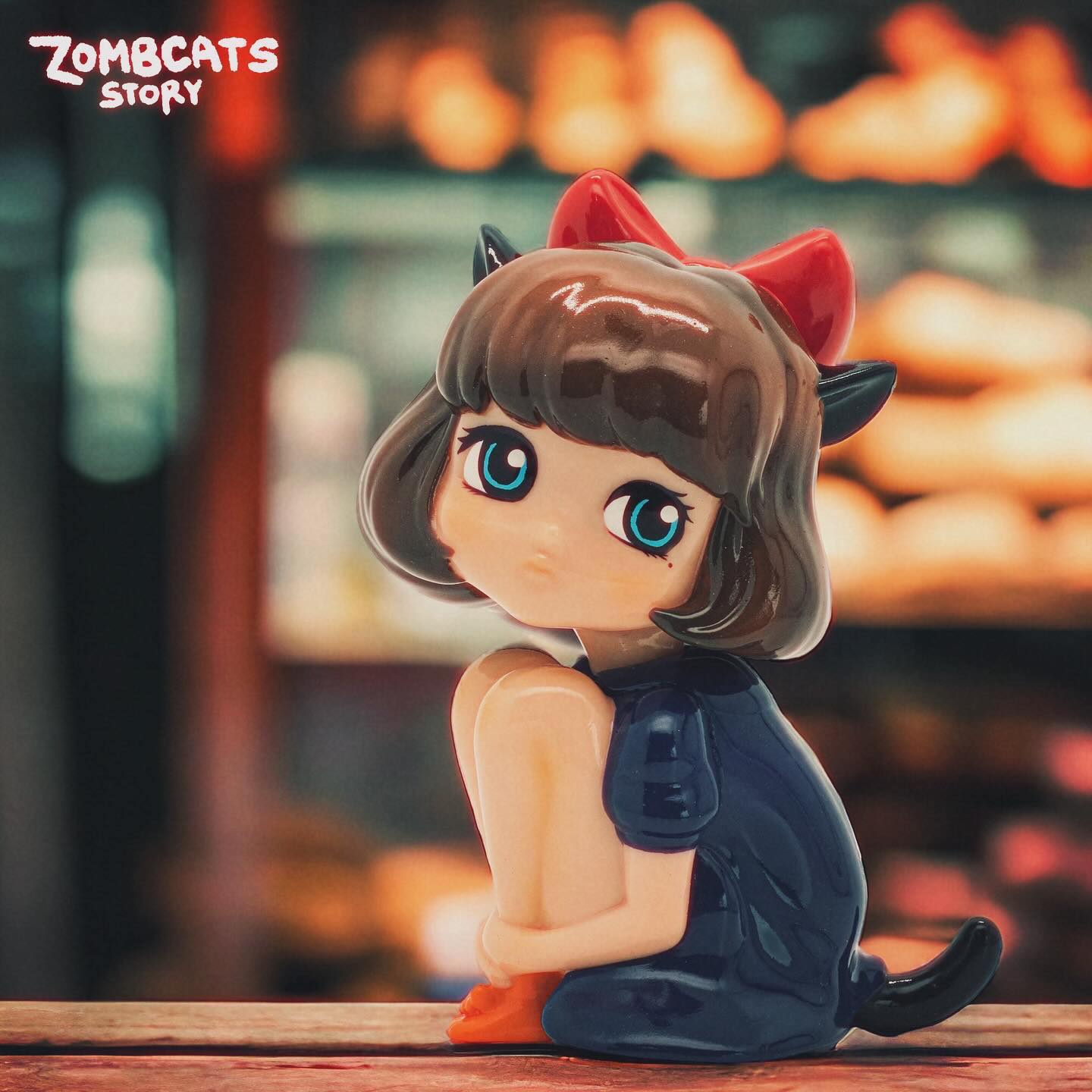 Nekomume figurine with doll and cartoon elements, limited edition toy girl and statue with horns, close-ups of high-heeled shoe and objects.