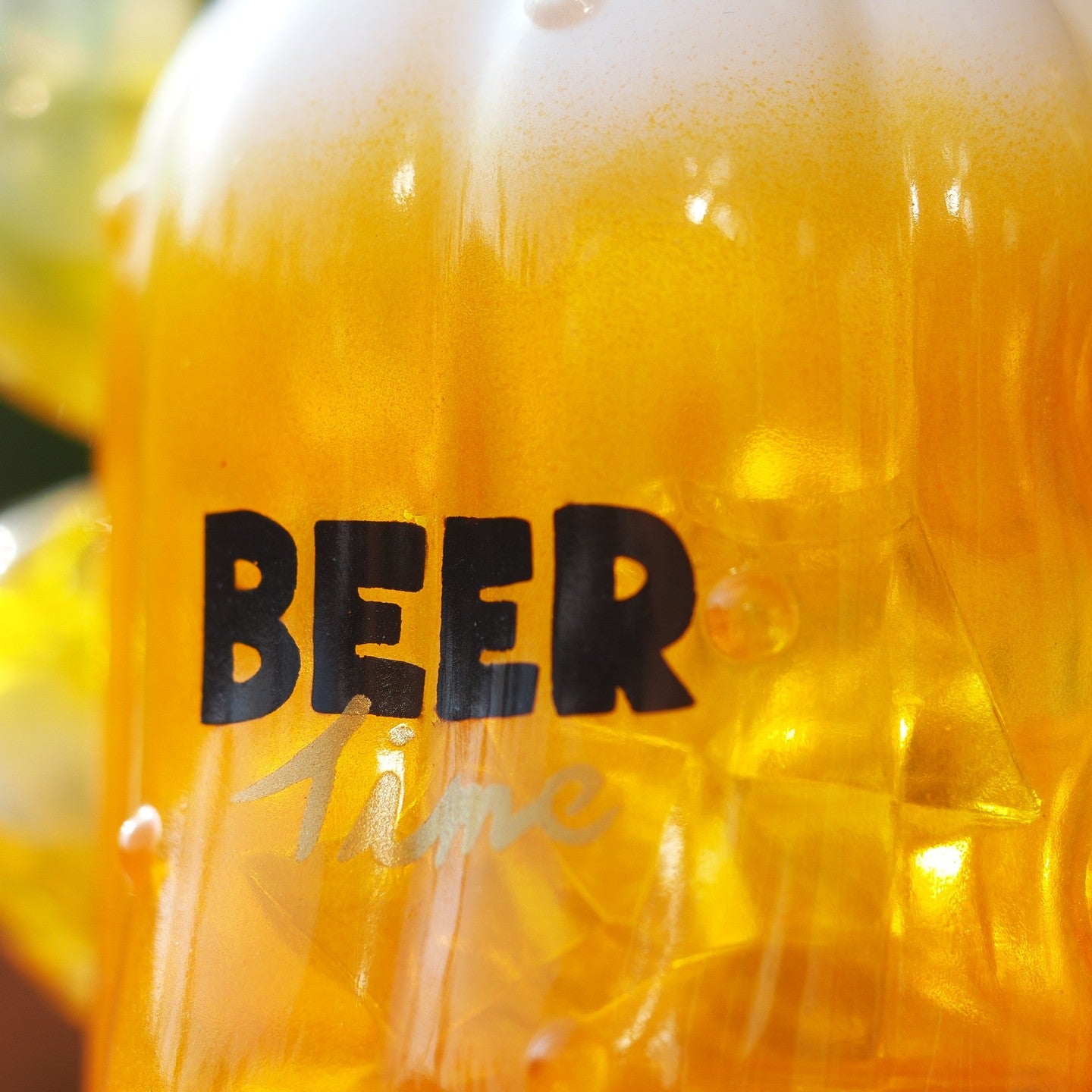 Close-up of BEER PATU soft vinyl bottle, 10 cm tall. Preorder - Ships Late May 2024. Featuring a glass of beer, a sign, and yellow liquid. From Strangecat Toys, a blind box and art toy store.