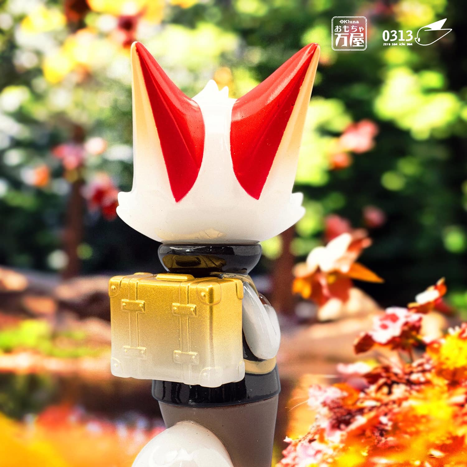 Traveler Phase 6 toy figure with ears and a crown on a gold suitcase. Preorder limited edition, 11cm soft vinyl from Strangecat Toys.