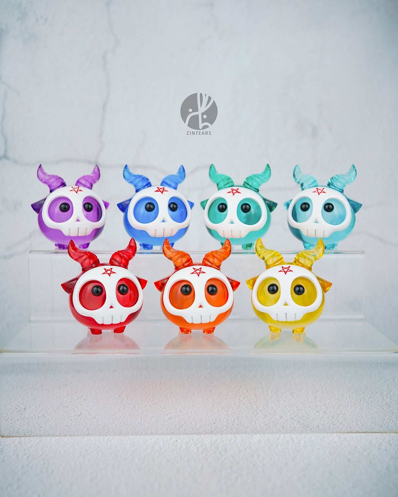 Yorick the skull - Orange Edition by Zintears, a translucent resin figure with horned mask, on display among colorful variants; limited to 50 pieces.