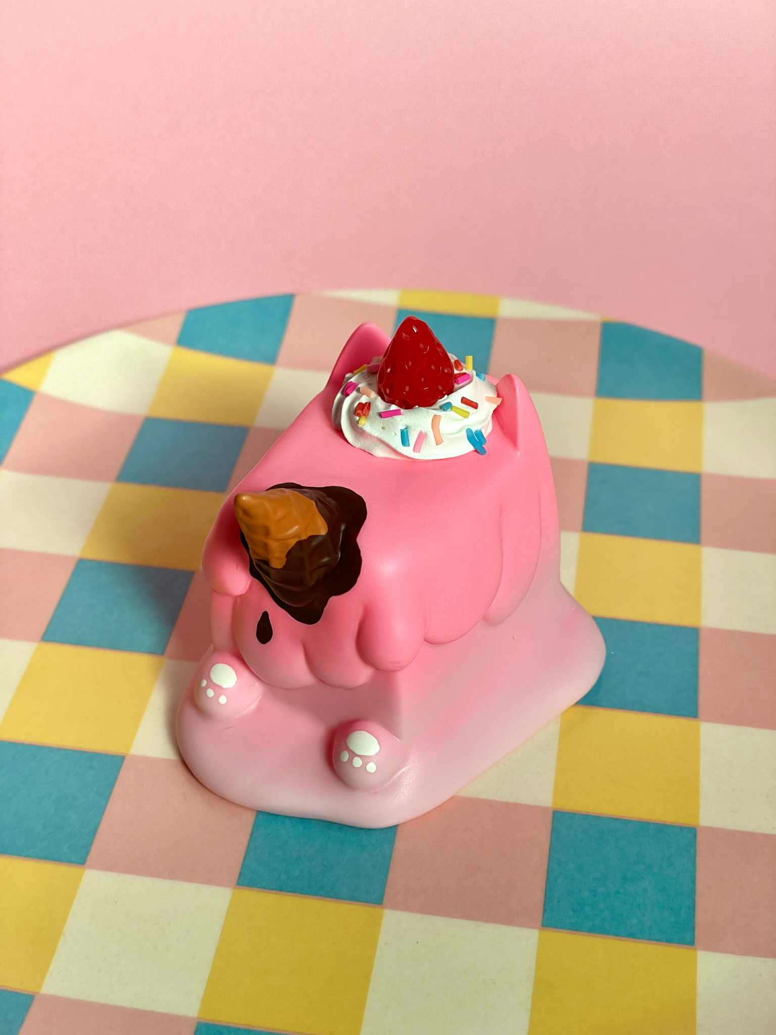 Strawberry Cream Ice Cream Cat by Rato Kim: A preorder vinyl art-toy resembling a melting pink cat with whipped cream, sprinkles, and chocolate sauce details.