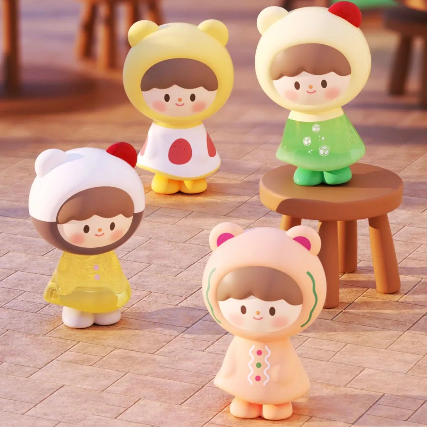 Four cartoon-like figurines from the zZoton Joy In A Twist Uliuli Mini Series Blind Bag, each wearing unique bear-ear hooded outfits, including one on a wooden stool.