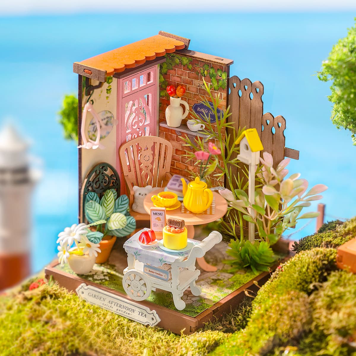 Rolife Fancy Tea Yard DIY Miniature House DS038 featuring a detailed outdoor tea scene with tiny plants, furniture, and teaware, ideal for collectors.