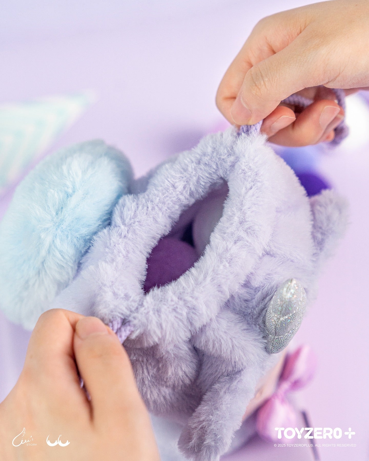 Hands displaying LuLu the Piggy LuLuLand - Drawstring Bag (Unicorn Lu ver.), a plush pouch with bunny ear handles, revealing plush shapes inside.