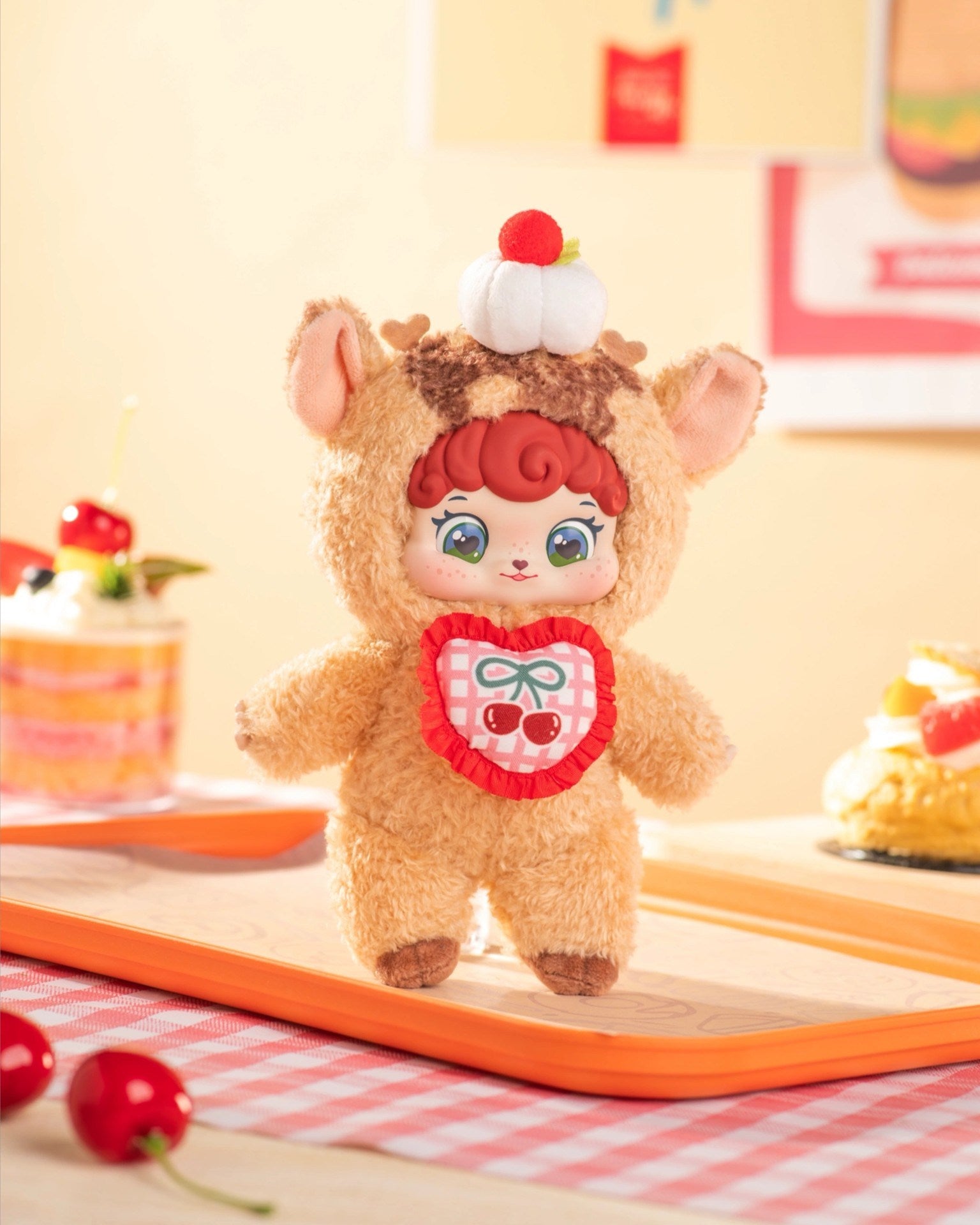 Puffynose Friend Memo Plush Pendant Blind Box shows a plush in an animal suit with cherries patch, on gingham cloth. Preorder for October 2025.
