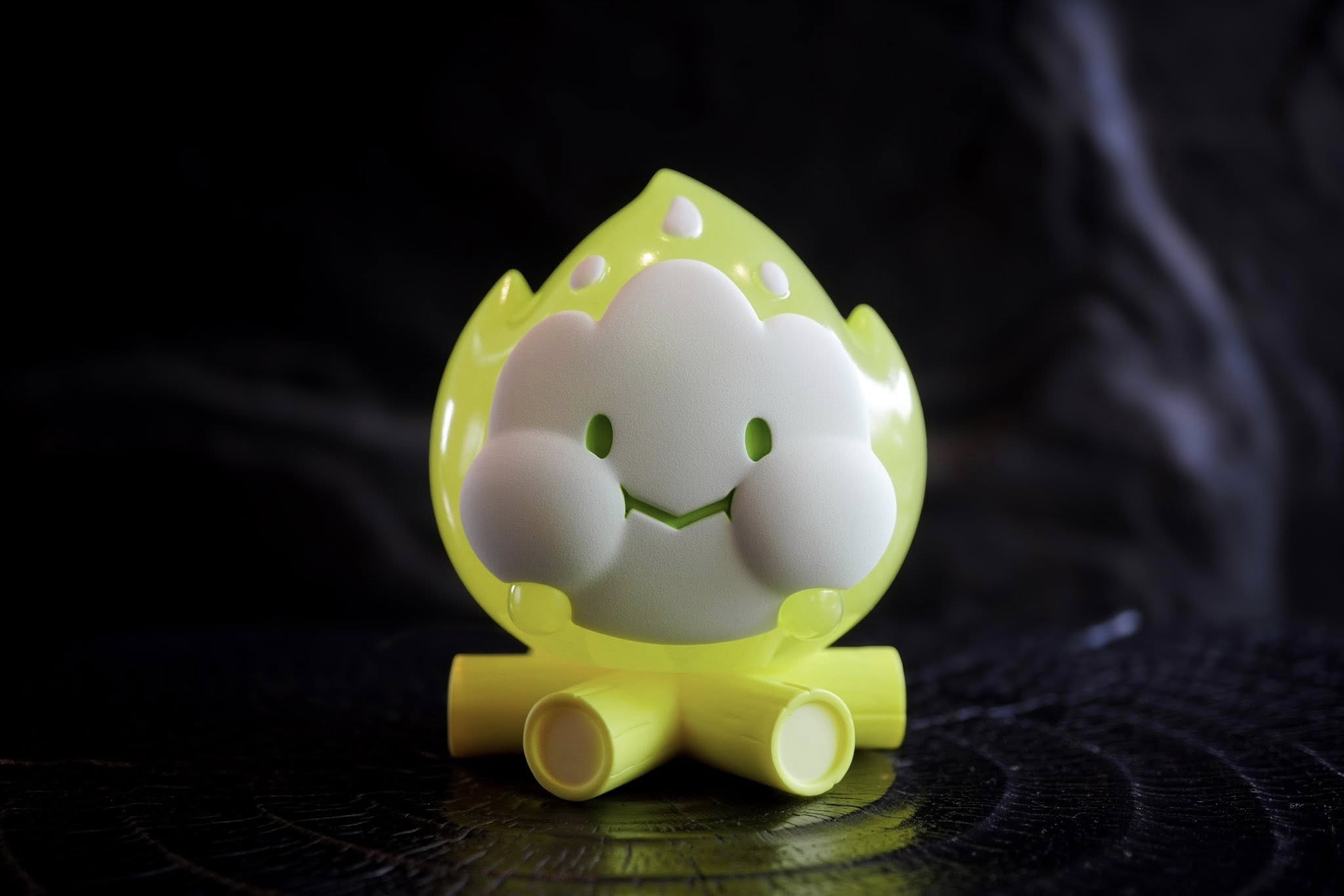 FLAMEY BON - Green Glow by MUPA Toy, a resin figurine with a cheerful flame character atop log cylinders, available for preorder at Strangecat Toys.