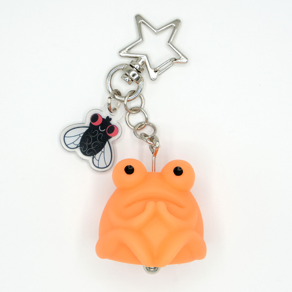Fruggie the Toad Bag & Key Charms by Horrible Adorables features a glowing vinyl toad and acrylic cicada on a star-shaped metal clip.