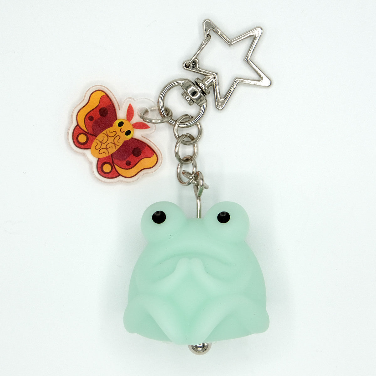 Fruggie the Toad Bag & Key Charm by Horrible Adorables features a glow-in-the-dark toad with a butterfly charm and star clasp.