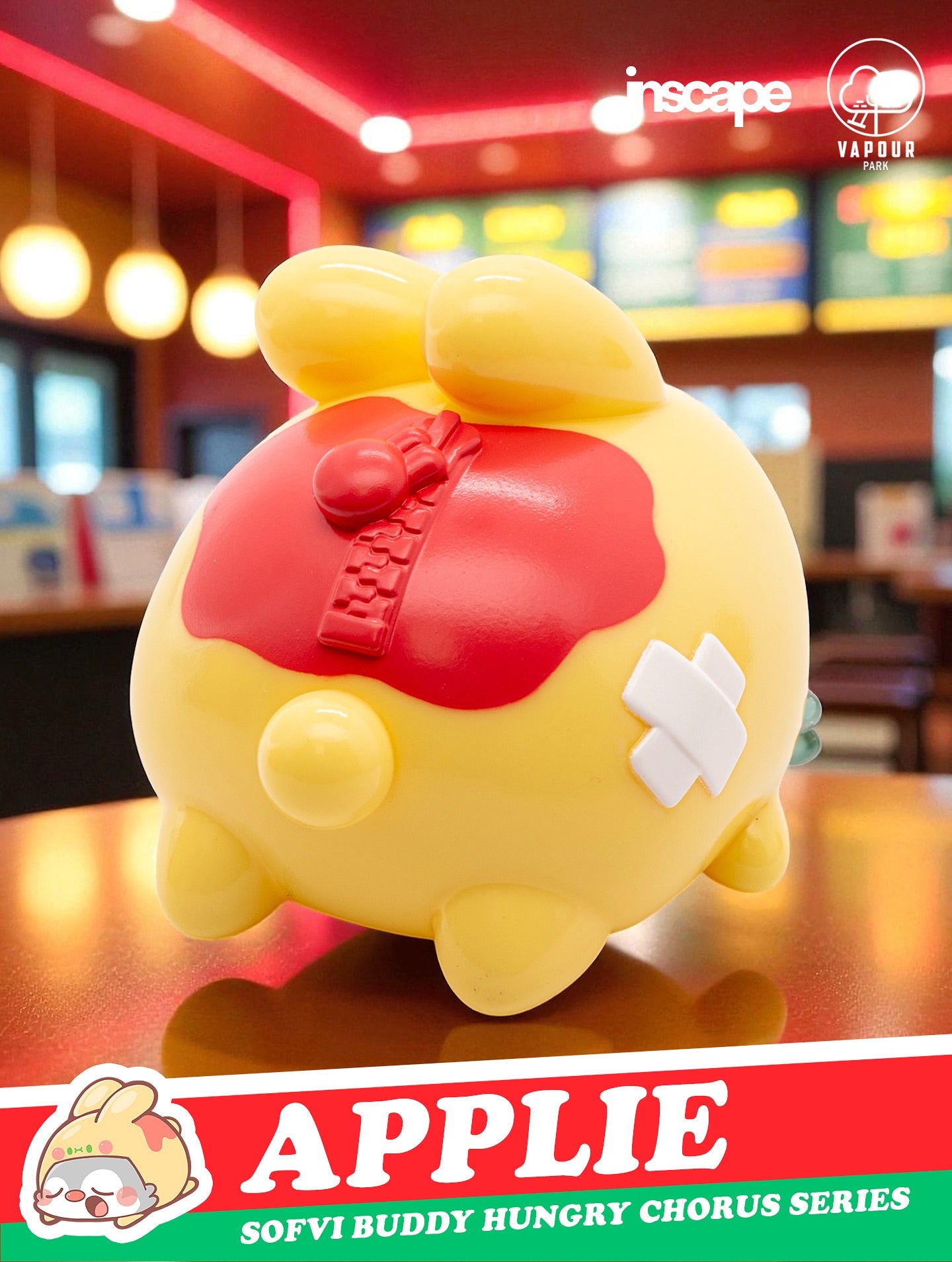 SOFVI BUDDY Blind Bag by Ngaew X OKluna - Preorder features a chubby yellow vinyl figure with red apple top, zipper detail, and bandage, on a café counter.