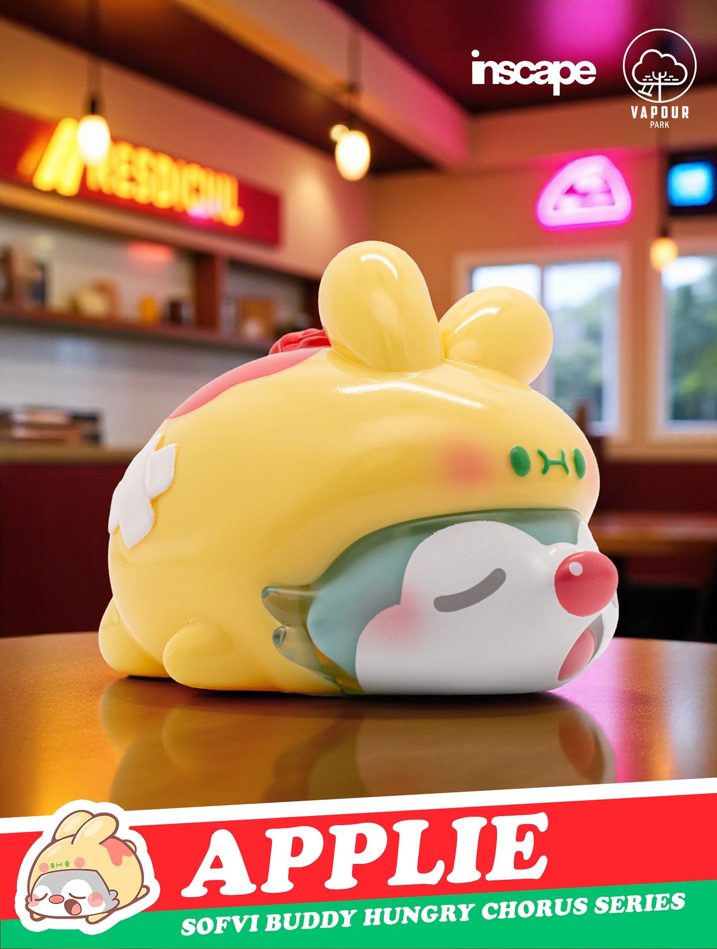 Collectible vinyl toy SOFVI BUDDY Blind Bag featuring a sleepy creature in apple-themed shell, displayed in a café setting. Preorder, ships Q4 2025.