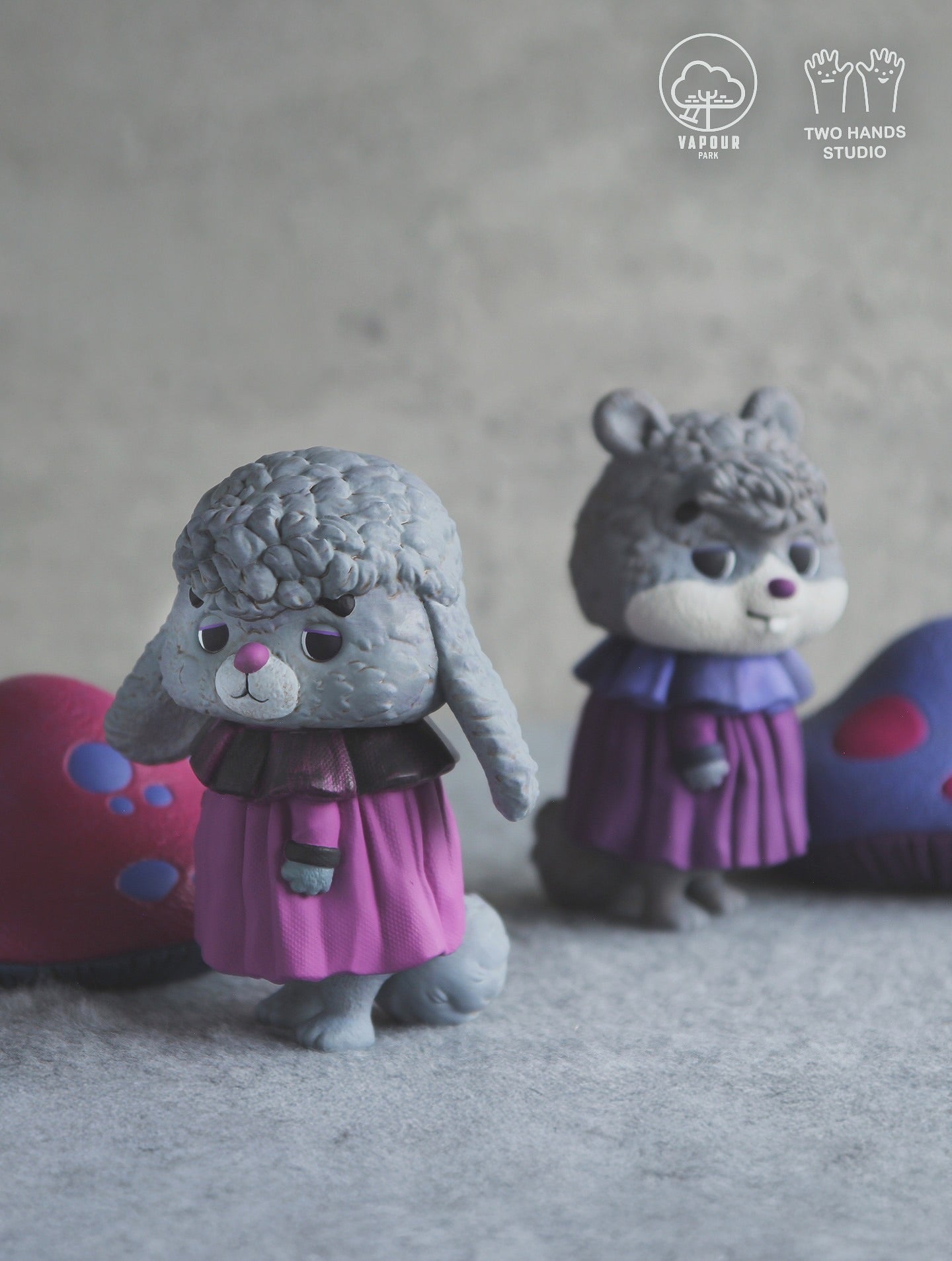 Mushroom Chipmunk Violet Edition figurines by Vapour Park X Two Hands Studio, featuring a poodle and rodent in colorful outfits with abstract props, available for preorder.