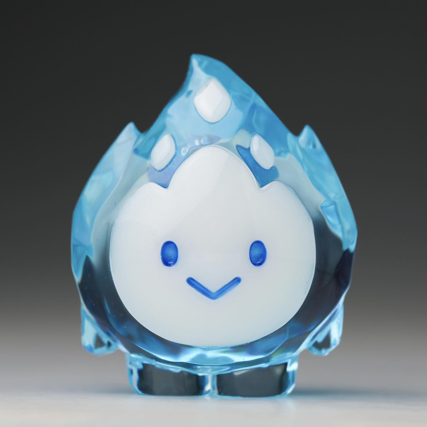 FLAMEY FROST - Blue Diamond by MUPA Toy, a 7cm limited-edition resin figurine, features a translucent blue flame with a smiling white face.