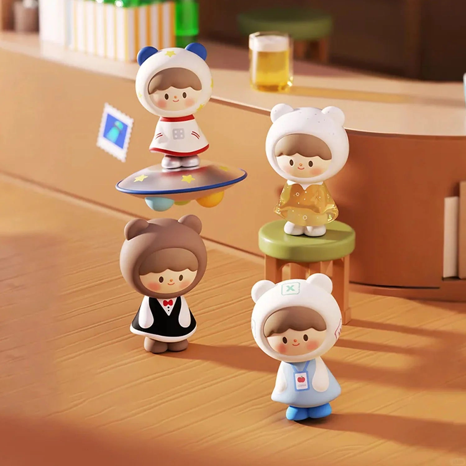 Four zZoton Joy In A Twist Uliuli Mini Series figurines, featuring whimsical characters with bear-ear hoods, displayed on a wooden surface.