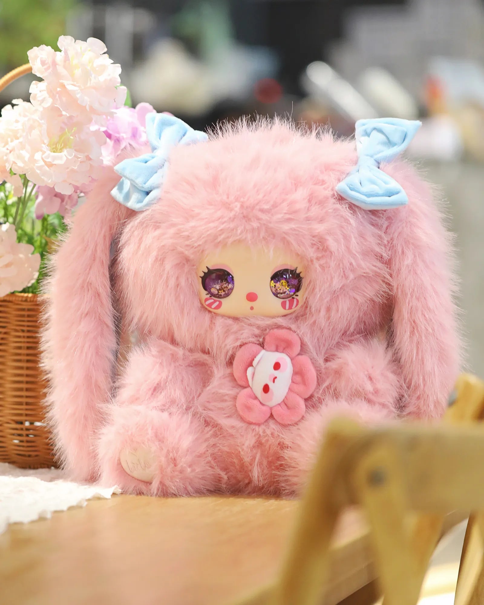 Liila's 600% 2V Tea Time With My Girl Plush Series Blind Box: A pink bunny plush with blue bows, cartoon eyes, and a flower appliqué.