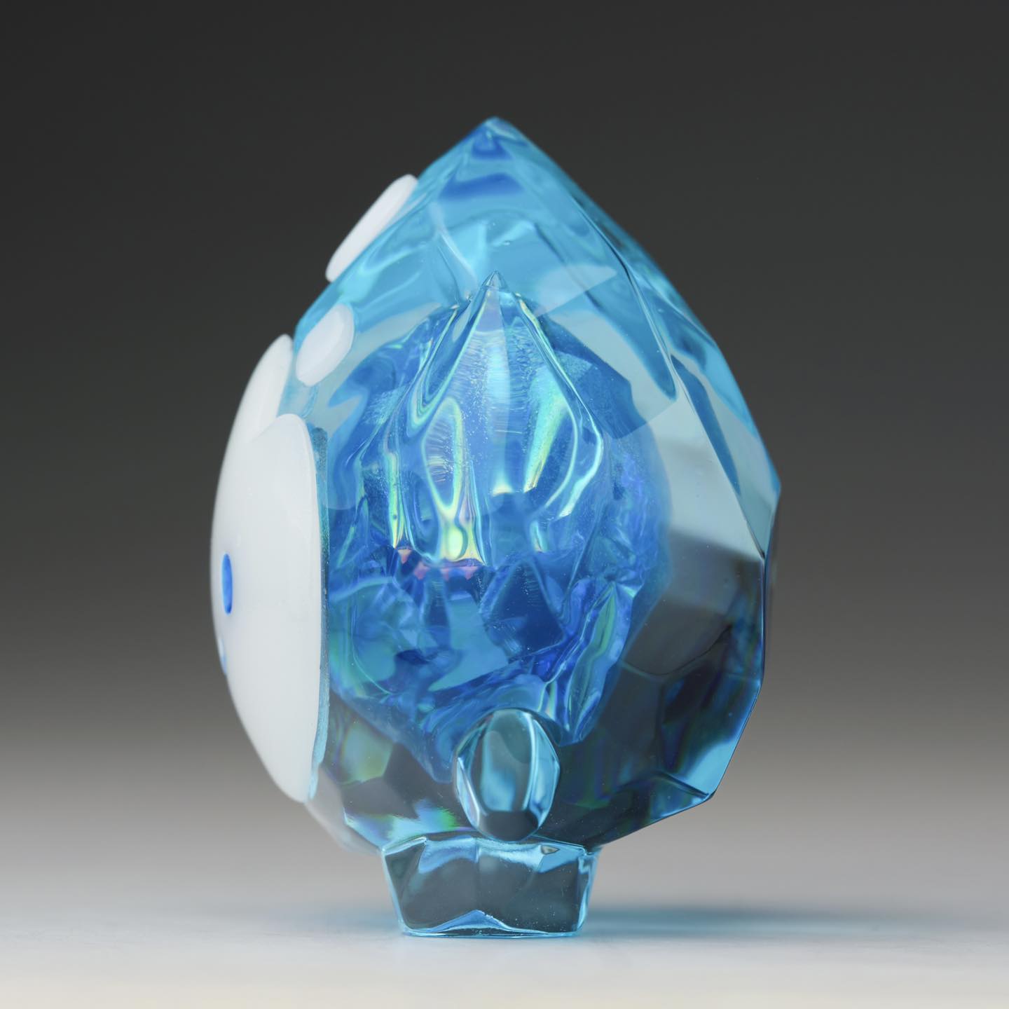 FLAMEY FROST - Blue Diamond by MUPA Toy; a resin, teardrop-shaped sculpture with faceted blue and smooth white accents; limited edition of 50 pieces.