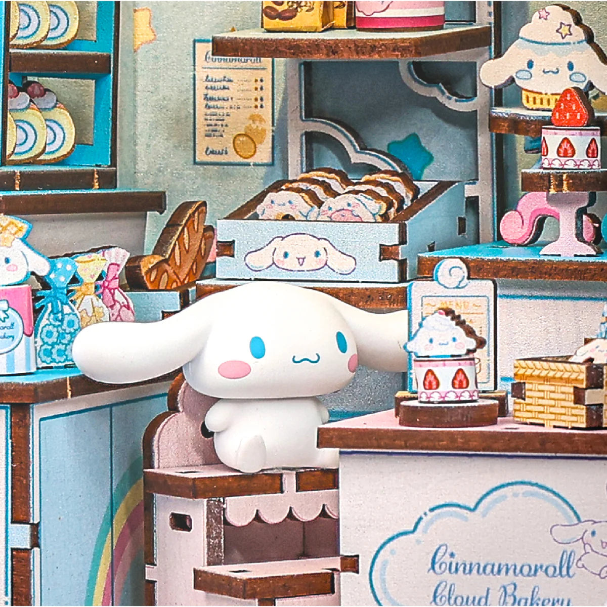 Cinnamoroll Cloud Bakery diorama featuring Cinnamoroll amid pastries, crates, and menus in a pastel bakery setting with LED light, ideal for collectors.