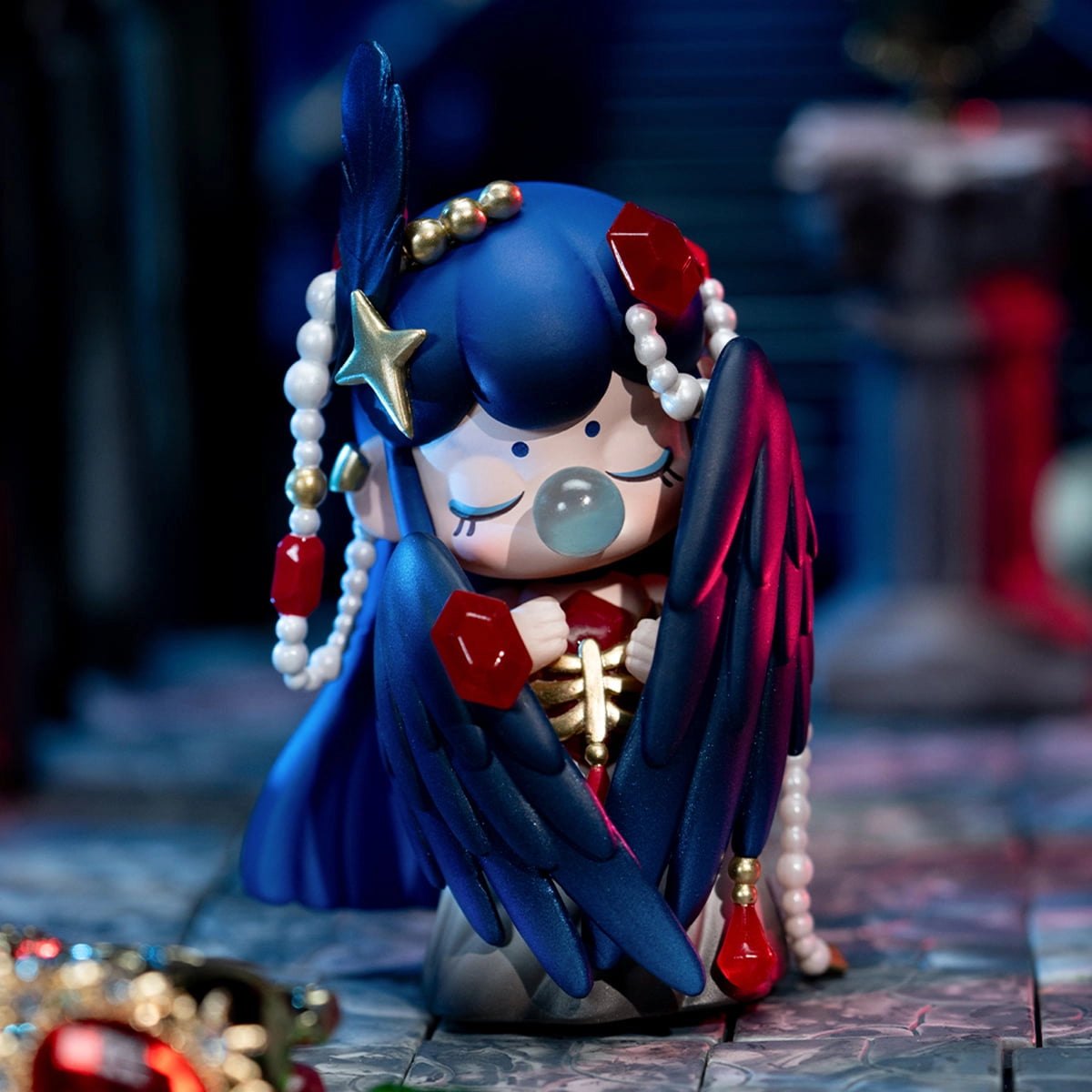 Nanci's Museum of Fantasy Blind Box Series figurine with blue hair, feathered wings, and ornate gems, embodying a mystical, gothic aesthetic.