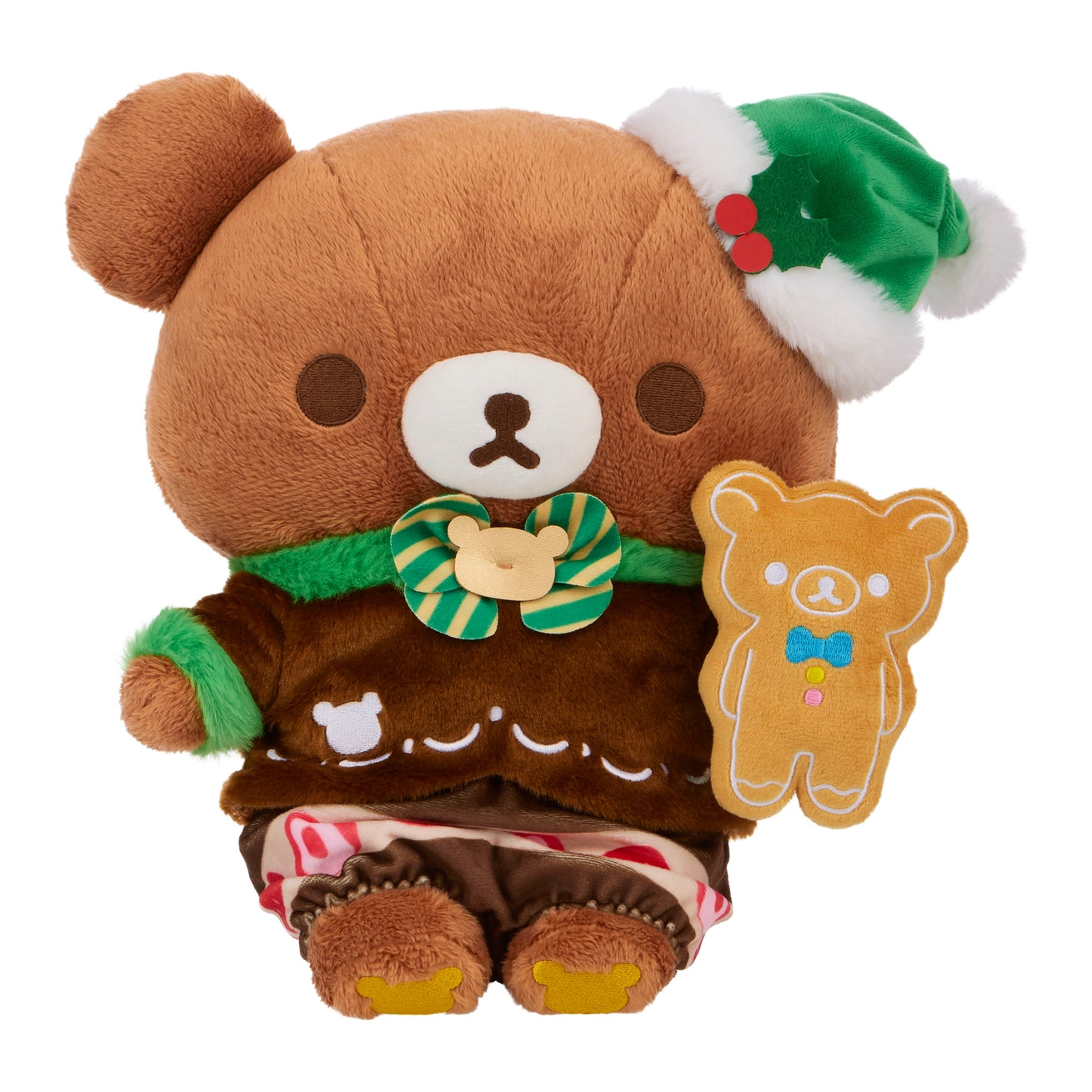 Chairo Holiday Cake Plush, an 11 Rilakkuma-inspired teddy bear in a gingerbread outfit, green hat, and bow tie, holds a bear-shaped cookie.