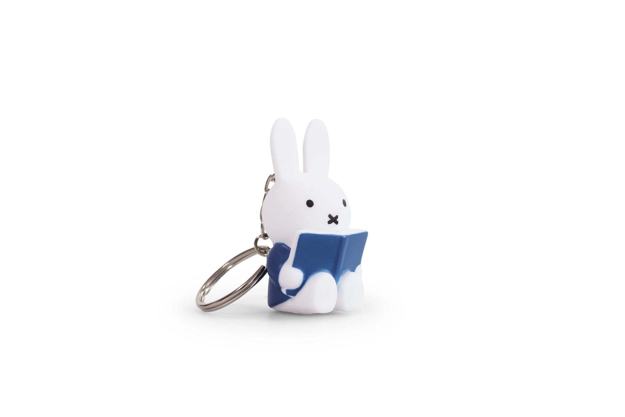 A whimsical Miffy Reading Keychain from Strangecat Toys: a white rabbit holding a book. 1.3x1x2.4 in plastic, CE certified, for ages 3+.