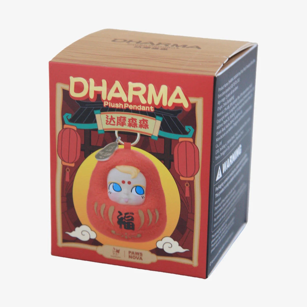 DHARMA SAMSAM VINYL FACE PLUSH PENDANT BLIND BOX showing a red Daruma-style plush keychain with a cat-like face in branded Paws Nova packaging.