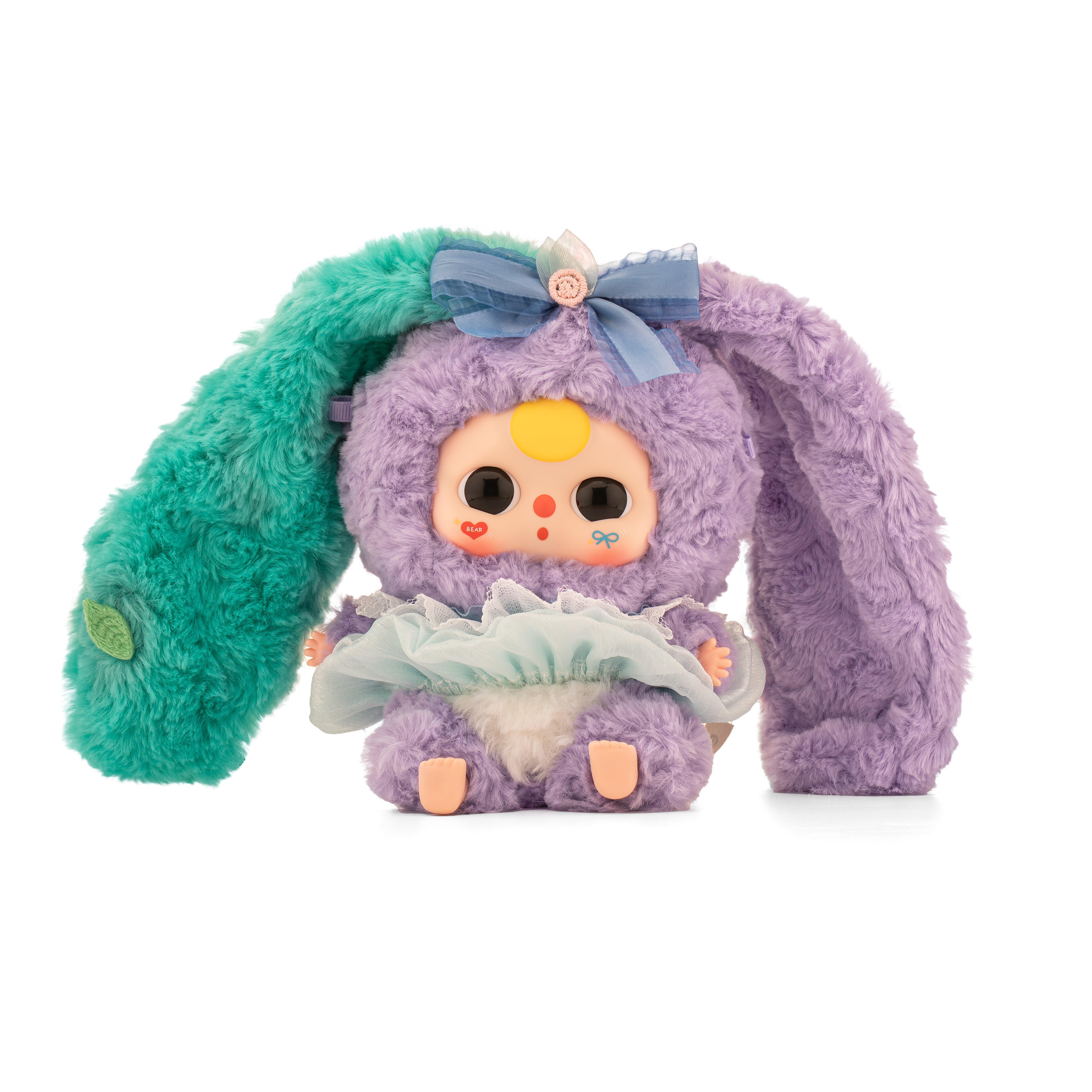 Baby Three - Lily Rabbit Town 4 plush doll in a fuzzy bunny costume, featuring a pastel tutu, vinyl face, and colorful ears, preorder for October 2025.