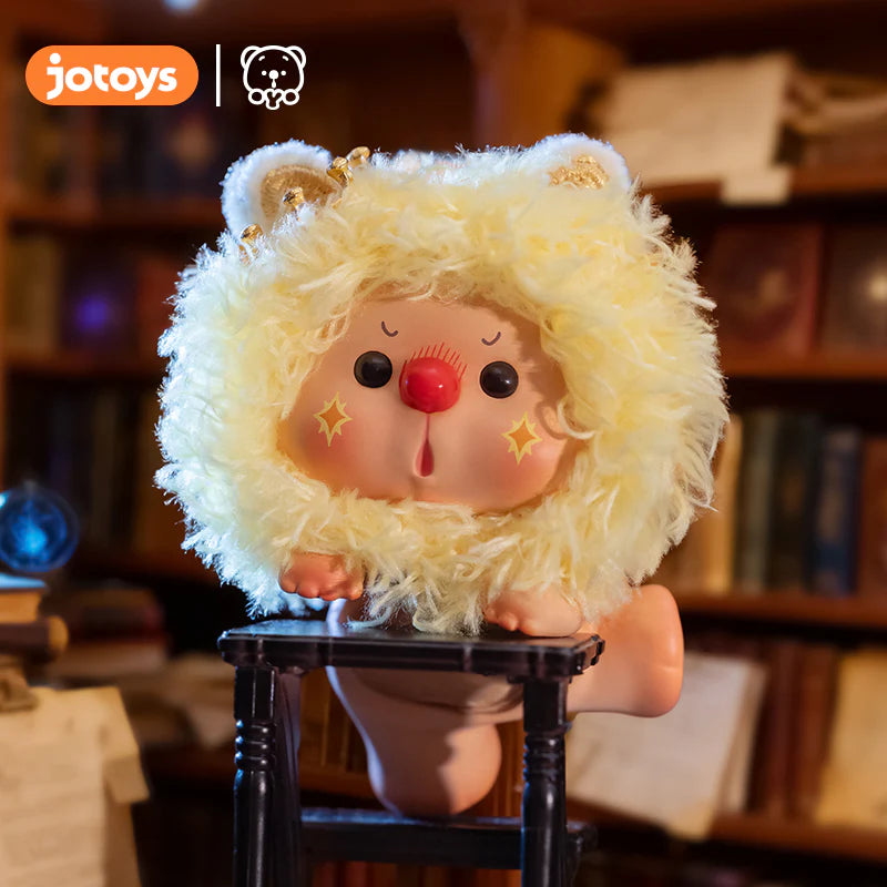 OYO Constellation Story Hipper Series Mini Blind Box: A chubby figure in a yellow lamb hood, red nose, star-blushed cheeks, on a black stand.