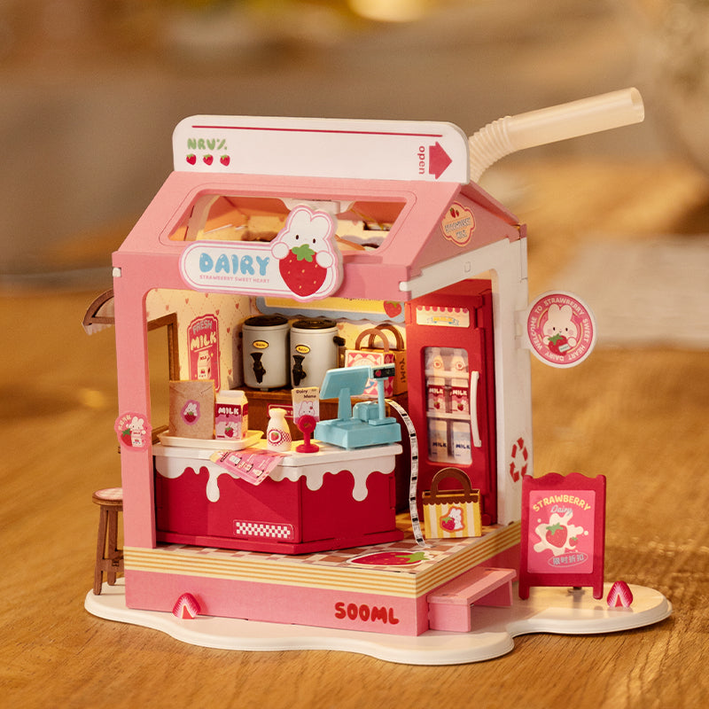 Strawberry Milk Box DIY Miniature House, a pink toy resembling a milk carton with strawberry accents, designed for assembly and pretend play, featuring a cartoon rabbit.