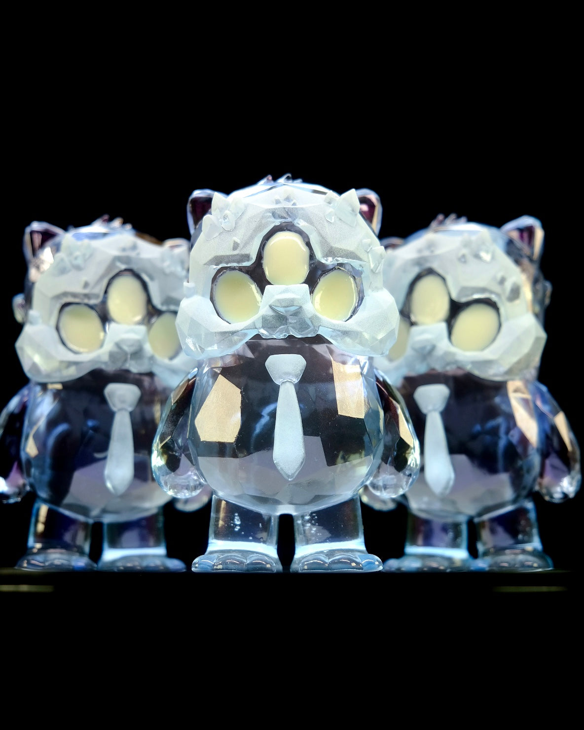 Beans Group Show - Arctic Beans by DTC Studios x Josh Divine features three semi-translucent resin bears with faceted bodies, crystalline masks, and neckties, available for preorder.
