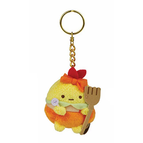 Sumikko Gurashi Halloween Plush Keychain Blind Box Series 12 features a chubby yellow bird with a red bow, orange skirt, and spatula, hanging from a gold chain.