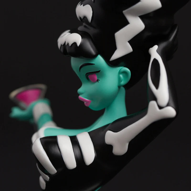 Bride Bones LIMITED EDITION RESIN FIGURE: A teal-skinned, skeletal-patterned art toy with a high black-and-white coiffure, holding a pink cocktail. Perfect for collectors.