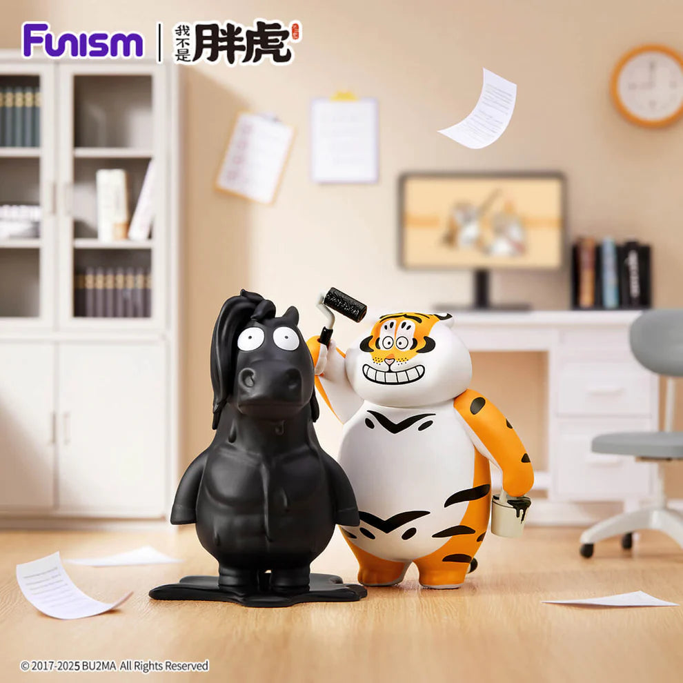 Alexander The Fat Tiger figure holds a paint roller, with a freshly painted horse sculpture nearby, in a staged office setting for this blind box series.